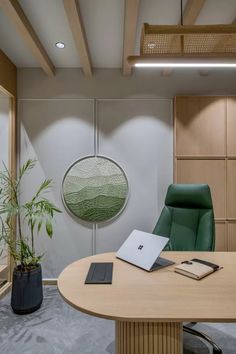 an office with a round table and green chair