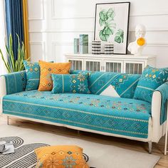 a living room filled with furniture and pillows on top of a white flooring area