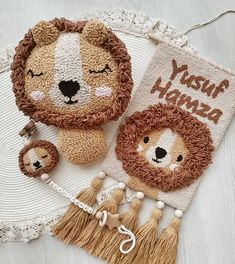 a lion and two lions are sitting on a doily with tassels next to each other