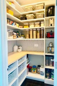 an organized pantry with white shelving and lots of food