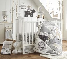 a baby crib with white woodland animals on it and the words top register pick