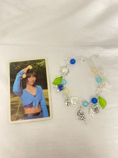 "twice's \"between 1&2\" inspired charm bracelet! comes with one of the official photocards as well as my usual kpop order freebies :)  ♡ shipping info - $5 shipping is included in the item cost! - i only deliver to the US on etsy, if you're outside the US and would like to purchase please dm my instagram @maseiremakes  ♡ sizing  - if you'd like the size to be adjusted, please leave the request in order notes :)  ♡ item care - item is completely handmade, so please be very delicate! - i would suggest avoiding water to preserve the item for as long as possible" Twice Bracelet, Earth Bracelet, Strawberry Charm, Cluster Bracelets, Bow Necklace, Myrtle Beach Sc, Silver Bow, Sweet Notes, Myrtle Beach