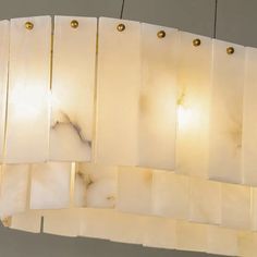 a chandelier made out of white marble tiles