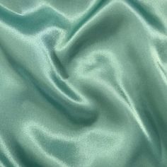 "Elevate your special occasion creations with Sedona Designz Premium Bridal Wedding Satin Charmeuse Fabric. Made from 100% polyester, this luxurious fabric boasts a lightweight feel that is both soft and smooth to the touch, making it the perfect choice for bridal gowns, bridesmaid dresses, and elegant evening wear. With a width of 60 inches, this fabric provides ample material for crafting exquisite garments that drape beautifully and exude sophistication. This high-quality satin charmeuse fabr Christmas Showcase, Mint Green Wedding, Elegant Evening Wear, Wedding Mint Green, Bella Wedding, Delicate Lingerie, Charmeuse Fabric, Gowns Bridesmaid, Flowing Fabric