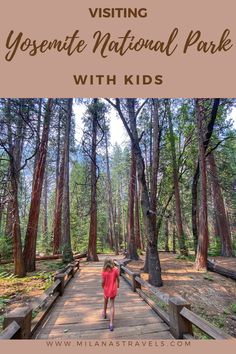 a woman walking across a wooden bridge in the woods with text overlay saying visiting yosemite national park with kids