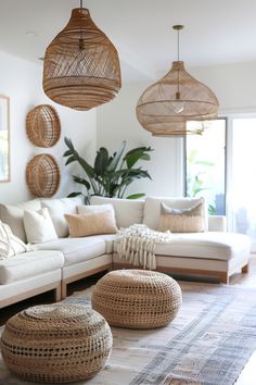 a living room filled with lots of furniture and hanging baskets on the wall above it