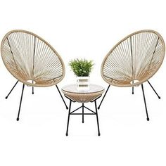 two wicker chairs and a table with a plant in it on a white background