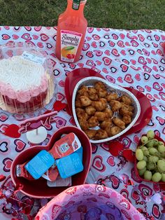 a table topped with lots of food on top of a red and white table cloth