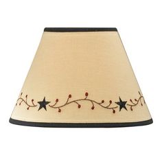 a lamp shade with stars and berries on it