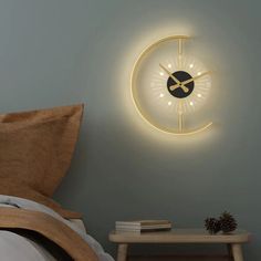 a clock that is on the side of a wall next to a night stand and table