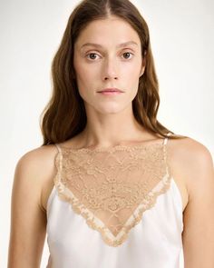 The Leeba Top in Soft White by By Malene Birger is a delicate, silk camisole featuring lace details and adjustable straps. 76% Acetate, 24% Polyester Q70365018