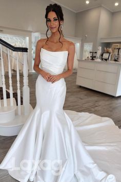 a woman in a white wedding dress posing for the camera with her hands on her hips