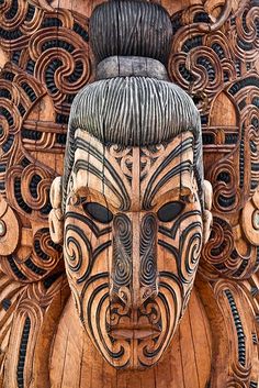 an intricately carved wooden mask is displayed