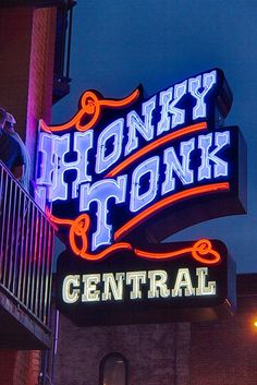 a neon sign that reads honey honk tonk central