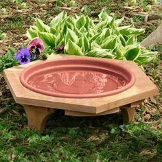 a wooden bird bath with water in it