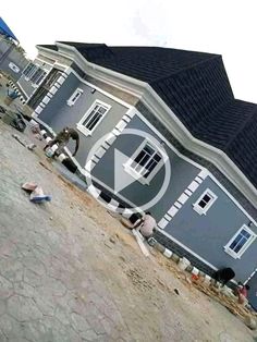 a house is shown with people sitting on the ground in front of it and an upside down camera