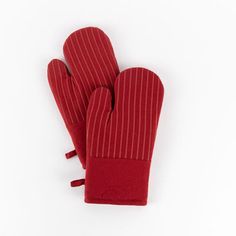 red oven mitts sitting on top of a white surface