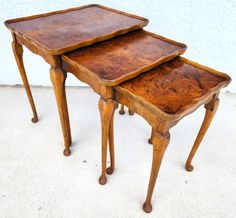 three wooden tables sitting on top of each other