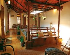 the inside of a house with wood floors and wooden benches on either side of the porch