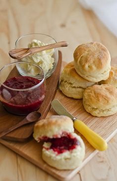 biscuits, jam and butter on a wooden cutting board