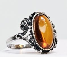 Vintage Sterling Silver Amber Ring SZ 7 See pictures for details 👀 Notea: - 925 sterling silver (stamped & tasted) - Size 7 - Oval amber (see pictures for dimensions) - Amber has minor abrasions (scratches) - Silver is toned (tarnished) Please contact me with any request(s) or question(s). I will answer as soon as possible 😊 All the best, -Luis Vintage Oval Cabochon Amber Ring, Vintage Amber Oval Cabochon Ring, Amber Topaz Sterling Silver Ring, Vintage Adjustable Amber Ring, Classic Amber Sterling Silver Ring, Antique Amber Cabochon Rings, Antique Amber-colored Sterling Silver Jewelry, Amber Ring, All The Best