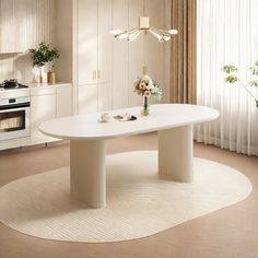 a white table sitting in the middle of a room next to a stove top oven