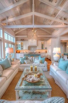 a living room filled with white furniture and lots of blue pillows on top of it