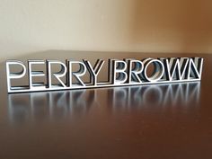 a metal name plate sitting on top of a table