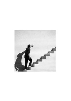 a man walking up some stairs with a surfboard