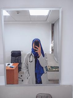 a person taking a selfie in front of a mirror with a stethoscope