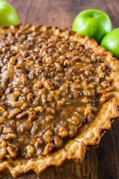 an apple pie sitting on top of a wooden table