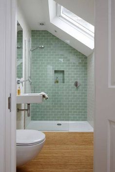 an open door leading to a bathroom with a skylight