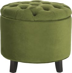 a green round ottoman sitting on top of a wooden table