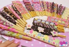 there are many decorated cookies and candy sticks on the table with pink polka dot dots