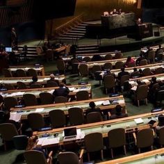 people sitting at desks in an auditorium