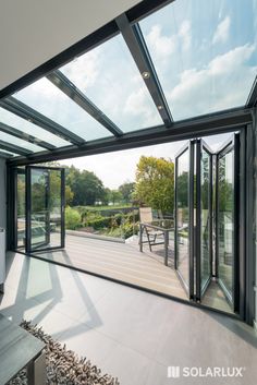 an open patio with sliding glass doors leading to a deck