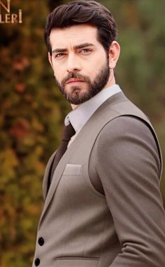 a man with a beard wearing a suit and tie