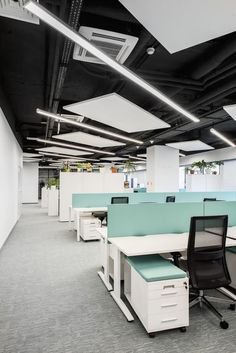 an office cubicle with two desks and one chair in the middle is empty