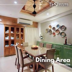 a dining room table and chairs with plates on the wall above it, in front of a green cabinet