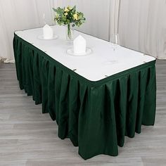 a white table topped with a green table cloth