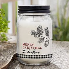 a christmas candle sitting on top of a wooden table