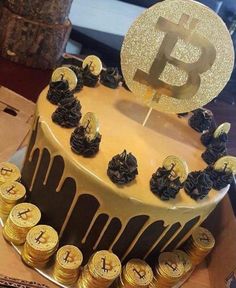 a cake decorated with gold and black decorations