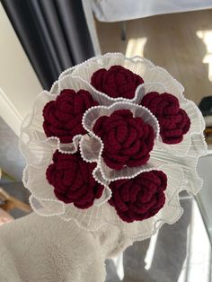 a bunch of red flowers sitting on top of a table