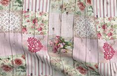 a pink and white striped fabric with flowers on the front, behind it is a flower arrangement