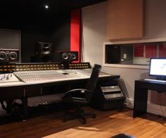 a recording studio with two monitors and sound equipment