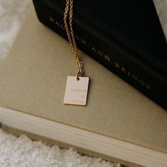 a book with a gold necklace on top of it