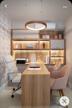 an office with two chairs and a desk in front of a book shelf filled with books