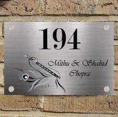 a metal plaque on the side of a brick wall that reads,'1934 mittin & shad chopra '