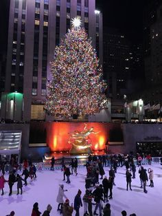 people skating on an ice rink in front of a christmas tree at rockefeller's