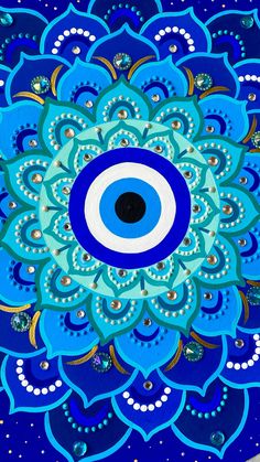 a blue and white flower with an evil eye on it's center, surrounded by smaller circles